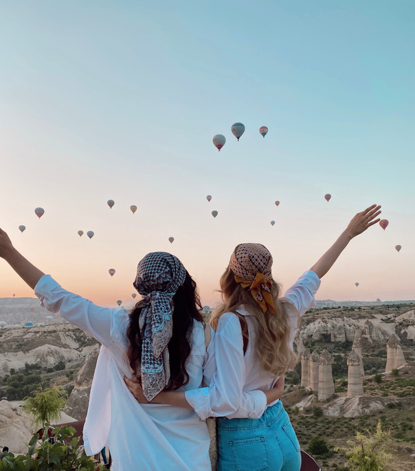 Two Women Wearing Headscarf Watching Hot Air Balloons in the Sky