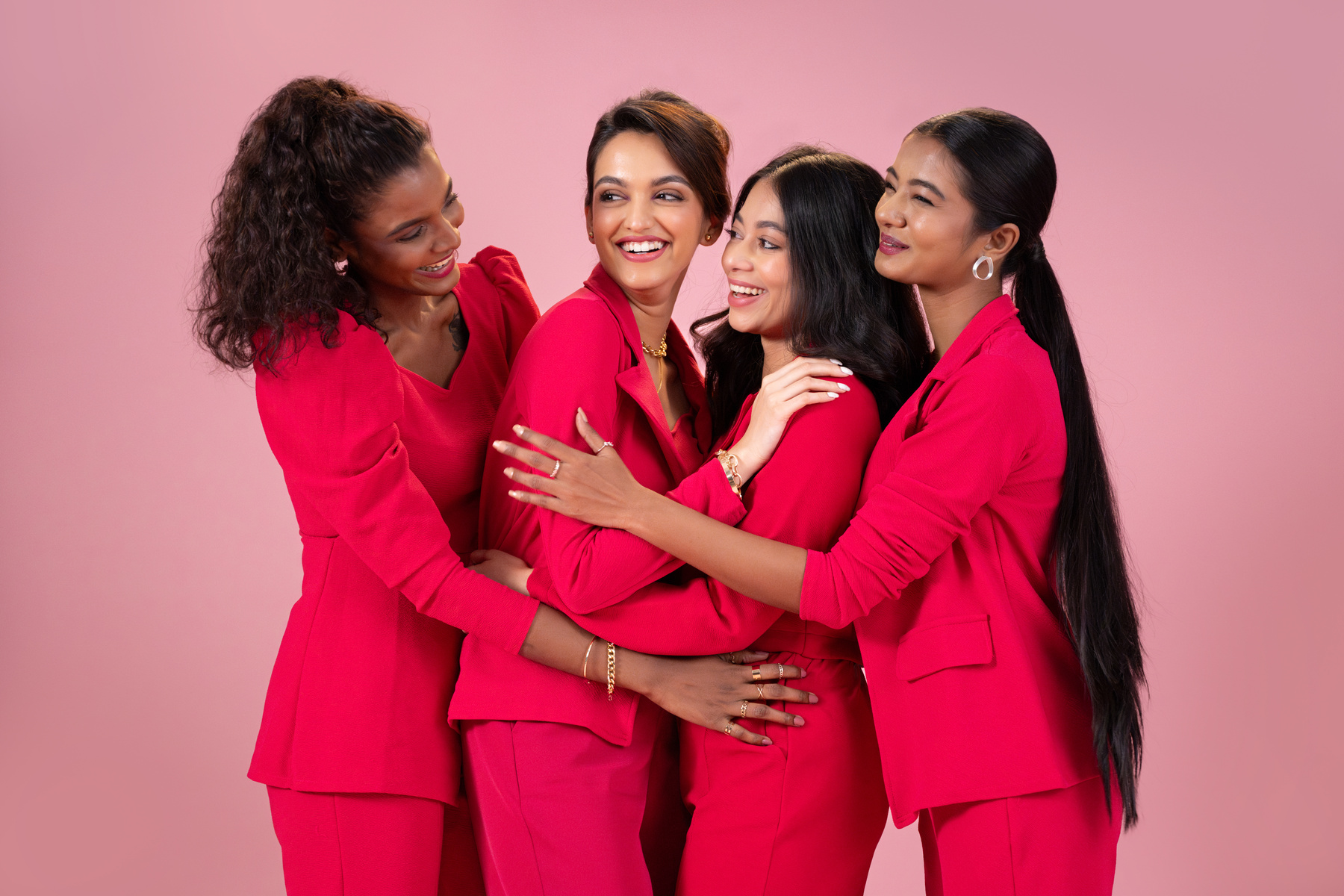 Four Business Women Standing Laughing